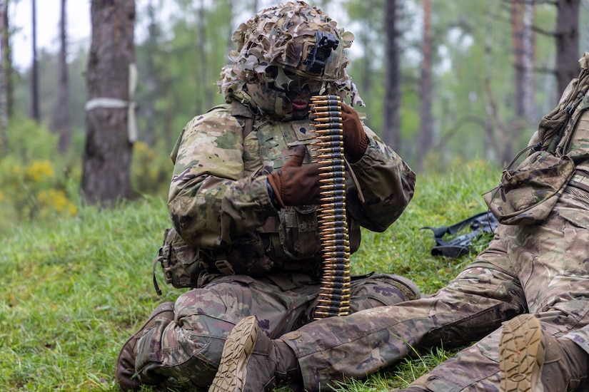 A soldier counts ammunition.