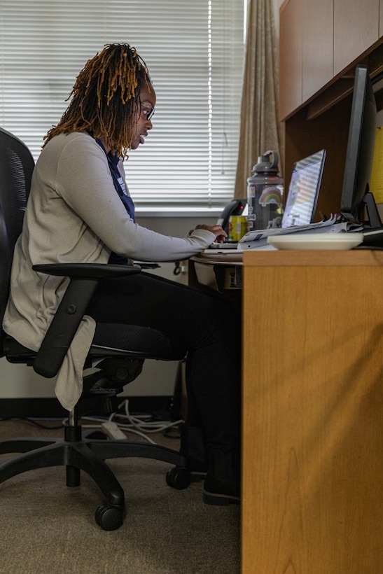 Catherine Matchem-Watkins, a Marine Corps Family Team Building Trainer with Marine Corps Community Services Iwakuni, writes a Letter of Appreciation for volunteers at Marine Corps Air Station Iwakuni, Japan, April 8, 2024. Matchem-Watkins, a native of Chicago, Illinois, learned time management skills at a young age that she continues to use to this day to effectively balance time with her family, work, and volunteering in her busy schedule. (U.S. Marine Corps Photo by Lance Cpl. Dahkareo Pritchett)