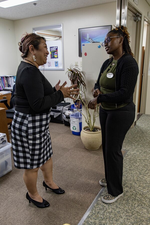 Catherine Matchem-Watkins, a Marine Corps Family Team Building Trainer with Marine Corps Community Services Iwakuni, talks with Miyuki Gray, a Japanese lifestyle, insights, networking, knowledge, and skills (L.I.N.K.S.) trainer with MCCS Iwakuni, at Marine Corps Air Station Iwakuni, Japan, April 29, 2024. Matchem-Watkins, a native of Chicago, Illinois, learned time management skills at a young age that she continues to use to this day to effectively balance time with her family, work, and volunteering in her busy schedule. (U.S. Marine Corps Photo by Lance Cpl. Dahkareo Pritchett)