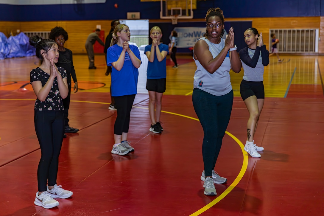 Catherine Matchem-Watkins, a Marine Corps Family Team Building Trainer with Marine Corps Community Services Iwakuni, coaches the youth cheer team at Marine Corps Air Station Iwakuni, Japan, April 29, 2024. Matchem-Watkins, a native of Chicago, Illinois, learned time management skills at a young age that she continues to use to this day to effectively balance time with her family, work, and volunteering in her busy schedule. (U.S. Marine Corps Photo by Lance Cpl. Dahkareo Pritchett)