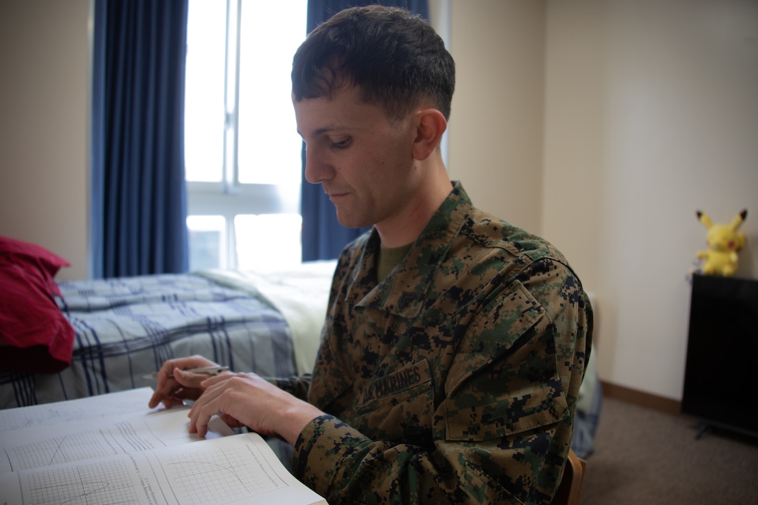 U.S. Marine Corps Cpl. Jacob Coby, a financial management resource analyst with Headquarters and Headquarters Squadron, Marine Corps Air Station Iwakuni, works on schoolwork to further his college degree while at MCAS Iwakuni, Japan, March 21, 2024. Coby, a native of Lake Forest, California, continuously seeks self-improvement through education and physical and mental health. (U.S. Marine Corps photo by Lance Cpl. Rylan Adcock)