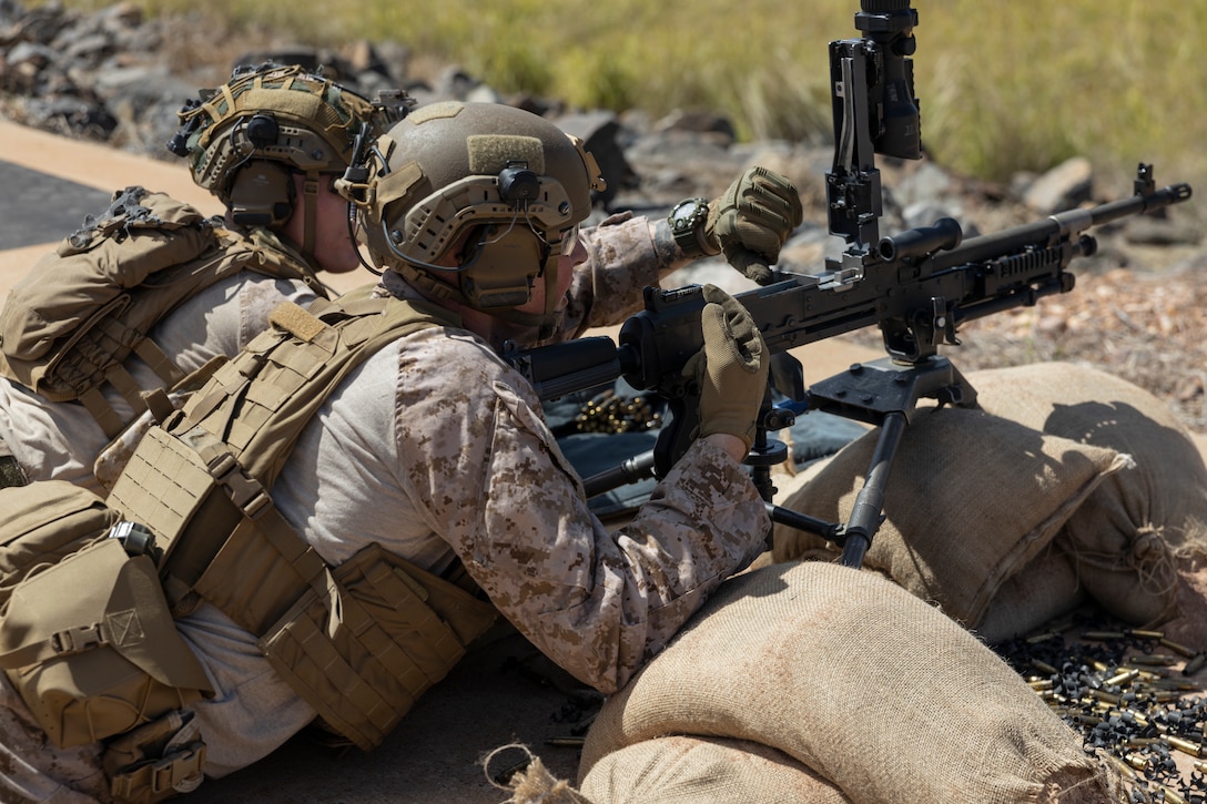 U.S. Marine Corps Sgt. Henry Bake, a vehicle commander with 2nd Battalion, 5th Marine Regiment (Reinforced), Marine Rotational Force – Darwin 24.3, clears an M240B medium machine gun during a battlesight zero range at Mount Bundey Training Area, NT, Australia, May 1, 2024. A BZO is the elevation and windage settings required to place a single shot, or the center of a shot group, in a predesignated location. MRF-D 24.3 is part of an annual six-month rotational deployment to enhance interoperability with the Australian Defence Force and Allies and partners and provide a forward-postured crisis response force in the Indo-Pacific. Bake is a native of Washington. (U.S. Marine Corps photo by Sgt. Cristian Bestul)