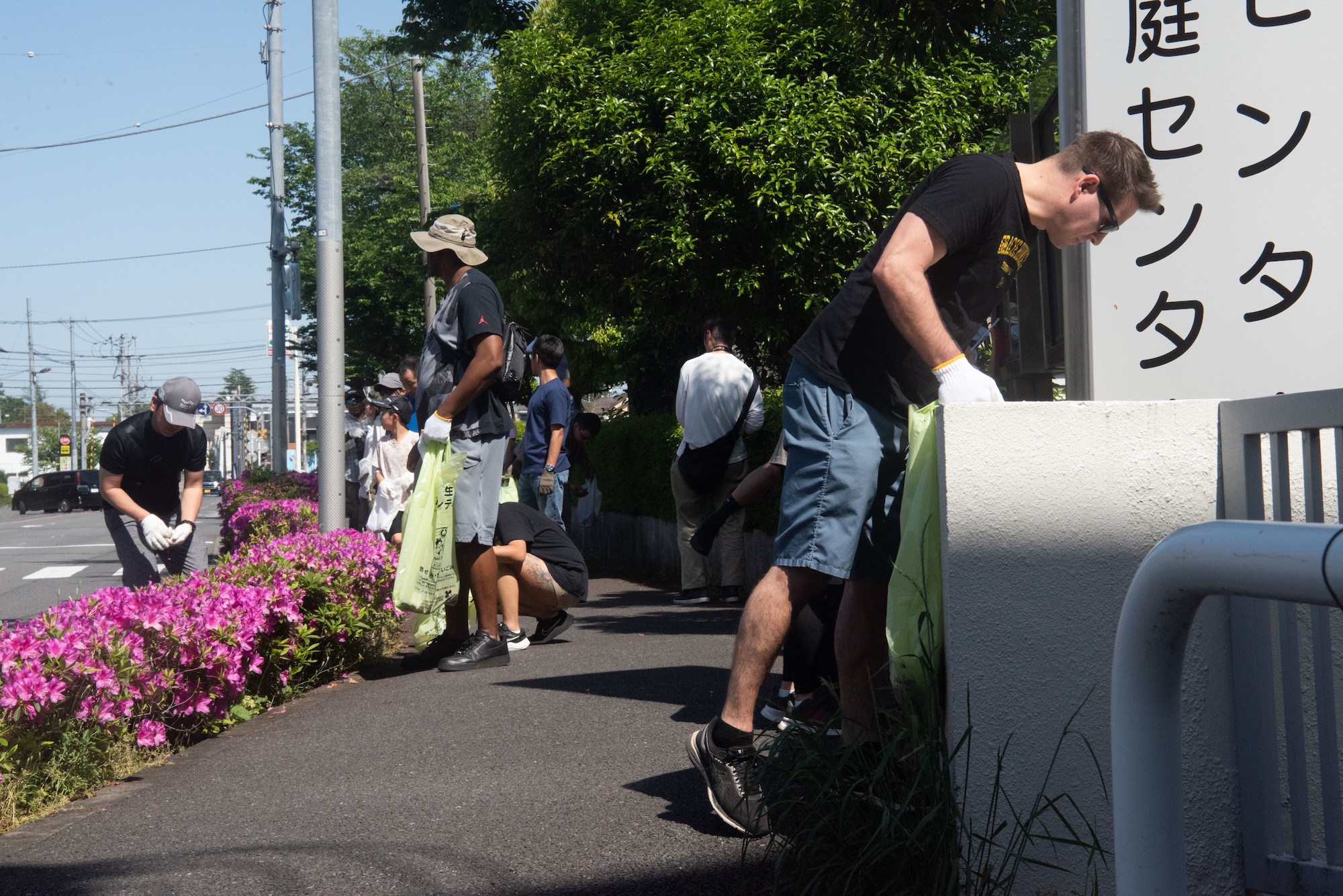 Participants look for litter around a sidewalk.