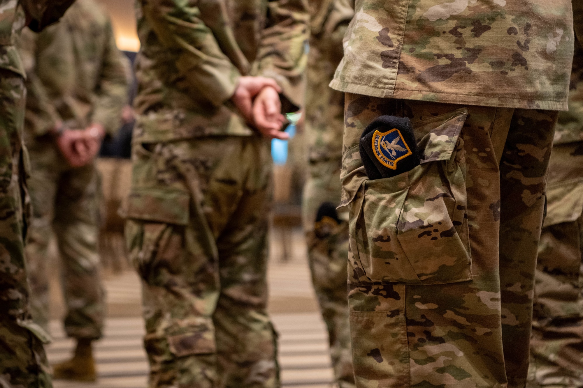 a security forces barrette sticks out of a military members pants pocket