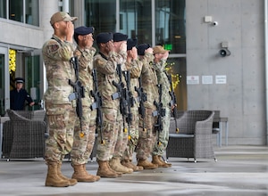 military members salute in a line