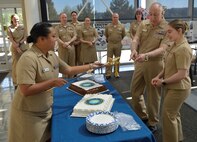 It was a piece of cake during NHB/NMRTC Bremerton's Nurse Corps 116th birthday celebration. As decorum dictated, the oldest Navy Nurse Corps officer was joined by the youngest for the traditional cake cutting. For the second year in a row, Capt. Patrick Fitzpatrick, NHB director and NMRTC Bremerton commanding officer and Lt. j.g. Taylor Fink wielded the ceremonial Navy sword. (Official Navy photo by Douglas H Stutz, NHB/NMRTC Bremerton).