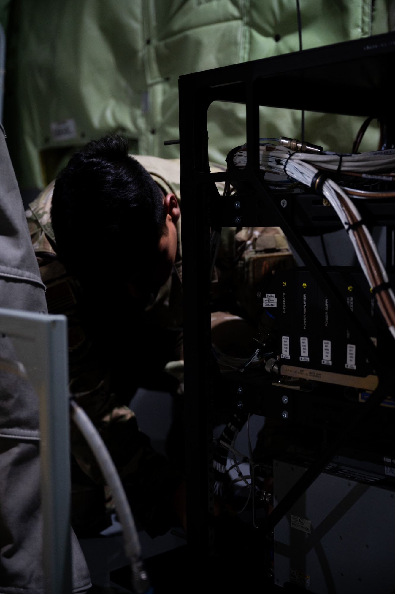 U.S. Air Force Tech Sgt. Steven Mashni, 434th Aircraft Maintenance Squadron electronic systems mechanic, inspects a terminal.