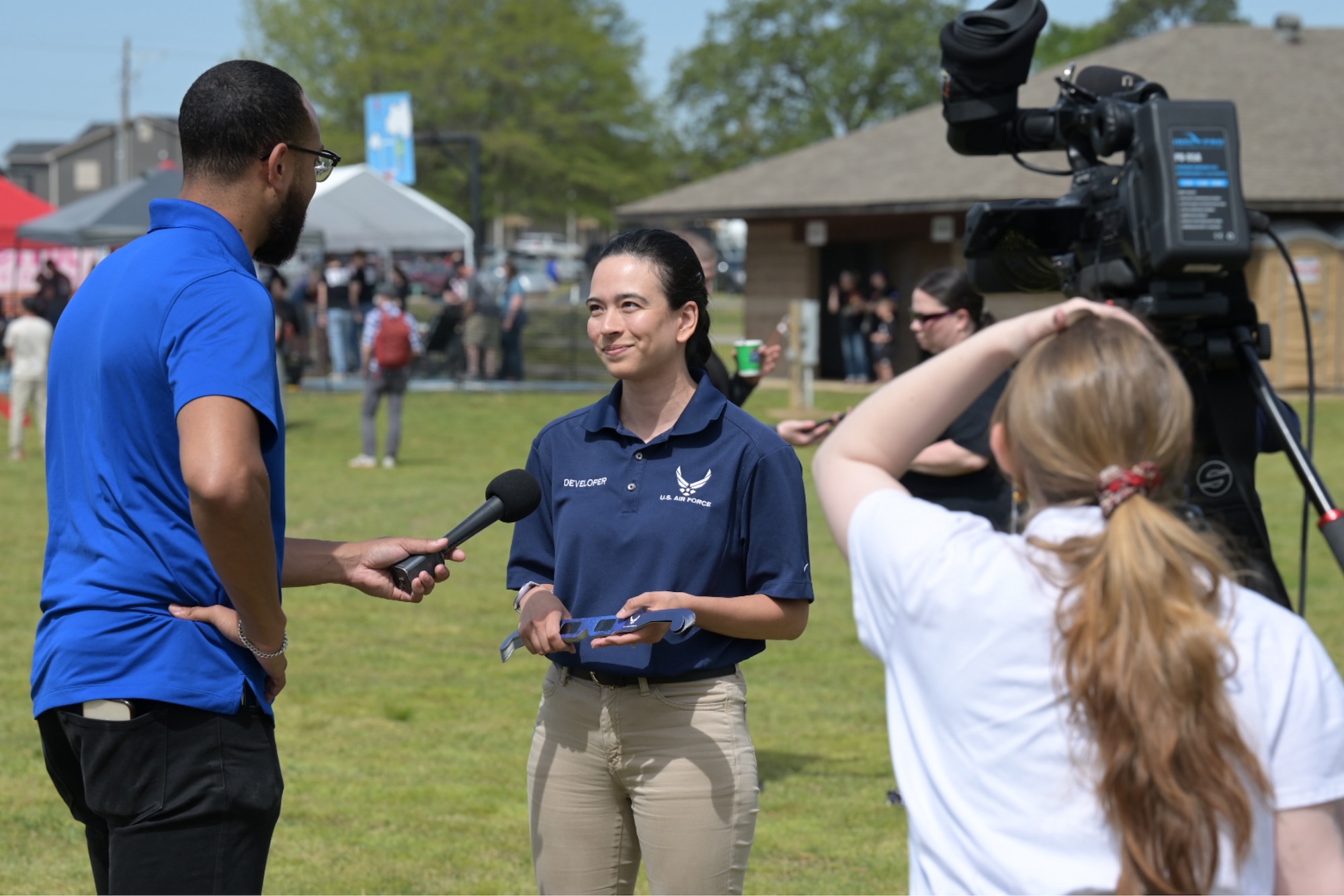 Staff Sgt. Vanesa Wagner speaks with KARK news about career opportunities in the Air Force on April 8, 2024, at a solar eclipse viewing event in Searcy, Arkansas.