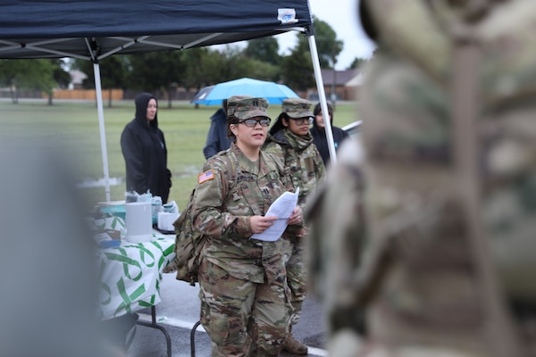 Capt. Courtney Huddleston, behavior health officer with the 45th Field Artillery Brigade, Oklahoma Army National Guard, speaks to ruck march participants during the 45th Field Artillery Brigade’s inaugural suicide prevention ruck march held at Wild Horse Park in Mustang, Oklahoma, May 5, 2024. The 45th FAB hosted the ruck march to raise awareness about suicide prevention and the resources available to Guardsmen, veterans and the local community. (Oklahoma Army National Guard photo by Sgt. Elliot Kim)
