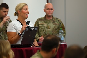 A spouse holding a microphone and asking a question.