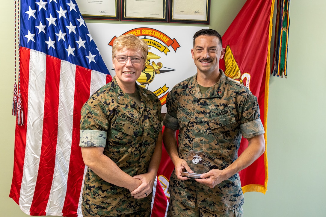 U.S. Marine Corps Col. Karin Fitzgerald, left, Commanding Officer, 2nd Combat Readiness Regiment, 2nd Marine Logistics Group, poses for a photo with Chief Warrant Officer 3 Brian Lautenslager a visual information officer with Headquarters and Service Battalion, 2nd MLG, the second-place finisher of an endurance course Camp Lejeune, North Carolina May 6, 2024.  U.S. Marines and Sailors competed and participated in endurance course events which consisted of a 3.2-mile-long mud run with various obstacles along the route to promote safety during the summer months, as well as strengthen unit cohesion, promote overall fitness and esprit de corps among all Major subordinate Commands of II MEFF. (U.S. Marine Corps photos by Lance Cpl. Christian Salazar)