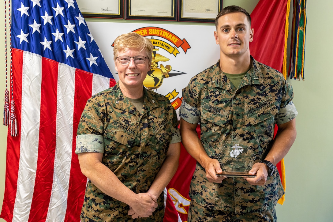 U.S. Marine Corps Col. Karin Fitzgerald, left, Commanding Officer, 2nd Combat Readiness Regiment, 2nd Marine Logistics Group, poses for a photo 1st Lt. Garrett Boden, a platoon commander with 6th Marine Regiment, 2D Marine Division, the first-place finisher in the endurance course on Camp Lejeune, North Carolina May 6, 2024.  U.S. Marines and Sailors competed and participated in endurance course events which consisted of a 3.2-mile-long mud run with various obstacles along the route to promote safety during the summer months, as well as strengthen unit cohesion, promote overall fitness and esprit de corps among all Major subordinate Commands of II MEFF. (U.S. Marine Corps photos by Lance Cpl. Christian Salazar)