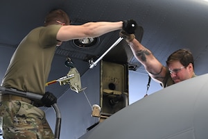 Master Sgt. Chad Conroy and Tech. Sgt. Dakota Perkins, aircraft fuel system craftsmen assigned to the 910th Maintenance Squadron, use a breaker bar to loosen the bolts that affix a fuel tank to the wing of a C-130H Hercules aircraft at Youngstown Air Reserve Station, Ohio, May 7, 2024.
