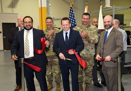 Leaders from the U.S. Army Medical Materiel Agency, U.S. Army Medical Logistics Command and Tobyhanna Army Depot cut a ribbon May 2 to celebrate a modernization project for USAMMA’s Medical Maintenance Operations Division at the installation in Pennsylvania. Pictured, from left, are Jorge Magana-Cortez, director of USAMMA’s Medical Maintenance Management Directorate; William Wall, MMOD-PA interim director; and Robert A. Lantka II, deputy to the commander, Tobyhanna Army Depot. (Photo Credit: C.J. Lovelace)