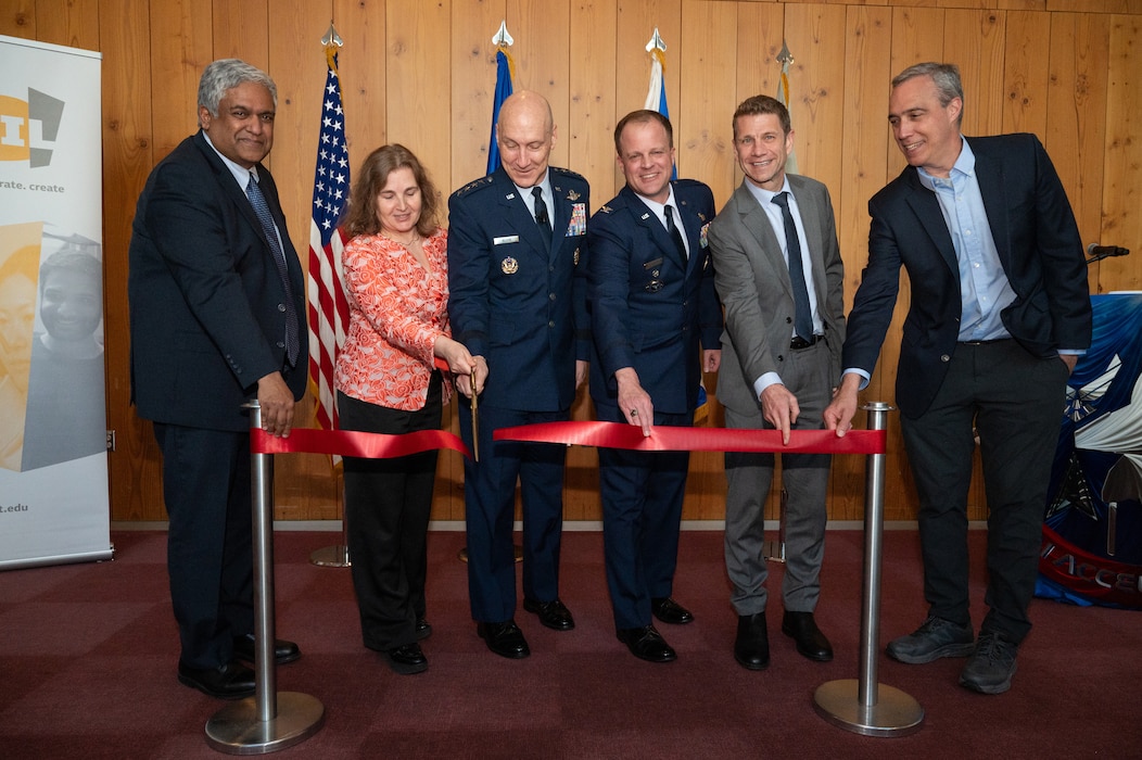 Air Force Chief of Staff Gen. David Allvin and other officials stand in front of a ribbon, preparing to cut it during a Department of the Air Force-Massachusetts Institute of Technology Artificial Intelligence Accelerator 2.0 event at MIT in Cambridge, Mass., on May 7. From left to right: Gen. David Allvin, Dean of MIT’s School of Engineering and Chief Innovation and Strategy Officer Anantha P. Chandrakasan, Professor Daniela Rus, MIT AIA director, Col. Garry Floyd, DAF AIA director, Dr. Justin Brooke, MIT Lincoln Laboratory assistant director, and Dean of the MIT Schwarzman College of Computing Daniel Huttenlocher.