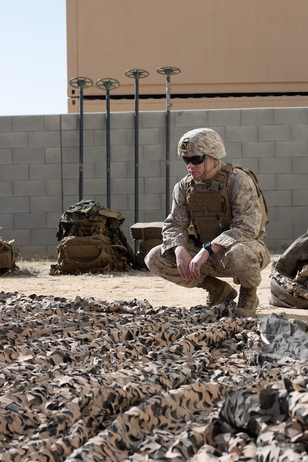U.S. Marine Corps 1st Lt. Brett Johnson, student with Marine Corps Communication-Electronics School, Training and Education Command, sets up a center of operations during Basic Communications Officer Course 1-24 at Range 800, Marine Corps Air-Ground Combat Center, Twentynine Palms, California, April 30, 2024. During the BCOC students learn about signal modulation, basic electrical concepts and how to build field expedient antennas. (U.S. Marine Corps photo by Lance Cpl. Anna Higman)
