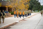 U.S. Air Force Basic Military Trainees march towards their initial haircut appointment at Joint Base San Antonio-Lackland, Texas, Dec. 14, 2023. Historically, trainees have used EZPay cards to pay for necessities only during basic training. Under the new EagleCash program, service members will be issued cards that stay with them throughout their career to also be used during military travel such as deployment or temporary duty assignments. (U.S. Air Force photo by Jarrod M. Vickers)