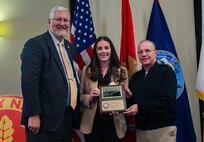 Vice Adm. David Lewis, USN (Ret.) and Chief Engineer and Deputy Commander for Ship Design, Integration and Naval Engineering, SEA-05, Naval Sea Systems Command Rear Adm. Jason Lloyd present the Rosenblatt Young Naval Engineer Award to NSWCPD’s Makayla Holt during the 2024 American Society of Naval Engineers (ASNE) Advanced Machinery Technology Symposium (AMTS), held at the Delta Hotel Philadelphia Airport in Philadelphia on May 1-2, 2024. (U.S. Navy Photo by Jay Butterbaugh/Released)