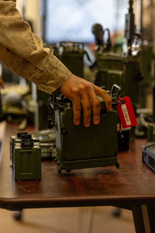 A U.S. Marine attending Expeditionary Communications Course 1-24 hosted by Marine Corps Communication-Electronics School prepares radios for the course’s culminating event at Marine Corps Air-Ground Combat Center, Twentynine Palms, California, May 2, 2024. ECC trains Marines in expeditionary skillsets that enable them to operate independently and to assemble various types of communication equipment in any environment across the full range of military operations. (U.S. Marine Corps photo by Lance Cpl. Anna Higman)