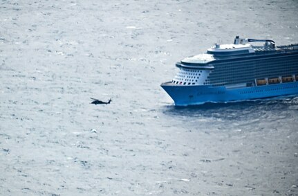 An HH-60 Pave Hawk helicopter prepares to engage with the Royal Caribbean cruise line ship Ovation of the Seas for a mission to transport a heart attack victim 400 miles off the coast of San Francisco May 7, 2024. This mission marked the 129th RQW's 1,161 life saved.