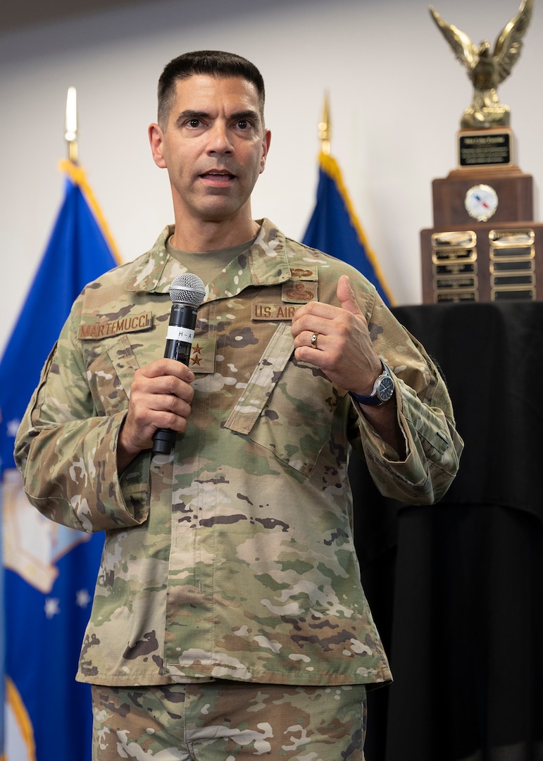 A man in military uniform speaks into a microphone