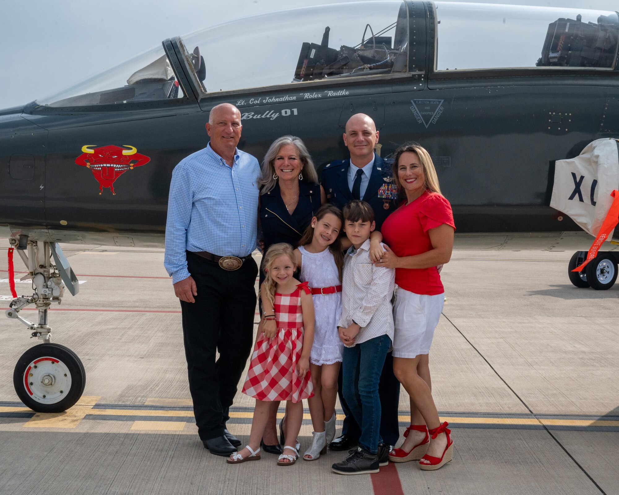 U.S. Air Force Lt. Col. Johnathan Radtke, 87th Flying Training Squadron (FTS) commander, poses with his family in front of the commander’s jet at Laughlin Air Force Base, Texas, May 9, 2024. The heritage tail for the 87th FTS has the name of the commander painted just under the cockpit glass, honoring the commander’s role in the unit. (U.S. Air Force photo by Staff Sgt. Nicholas Larsen)