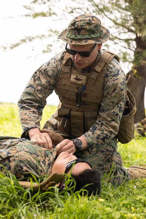 U.S. Navy Hospital Corpsman 2nd Class Daniel Severin with 6th Air Naval Gunfire Liaison Company, Force Headquarters Group, Marine Forces Reserve, renders tactical combat casualty care to a simulated casualty during Katana Strike 24 at Iejima, Okinawa, Japan, May 7, 2024. Katana Strike 24 is an annual exercise designed to further strengthen 5th ANGLICO's ability to conduct long-range communications and dynamic targeting cycles between joint ground, naval and aviation units in support of multi-domain operations. Severin is a native of Georgia. (U.S. Marine Corps photo by Cpl. Bridgette Rodriguez)