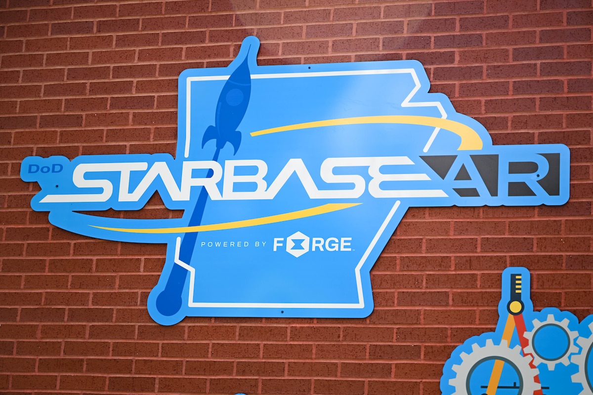 A STARBASE sign hangs on a wall