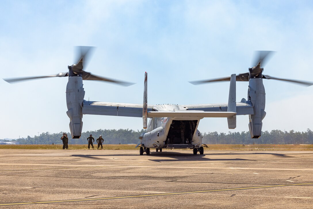 U.S. Marines with Marine Medium Tiltrotor Squadron 268 (Reinforced), Marine Rotational Force – Darwin 24.3, direct an MV-22B Osprey into position at Royal Australian Air Force Base Darwin, NT, Australia, May 11, 2024. The Ospreys were flown from Port Darwin to the RAAF Base Darwin, where they will be hosted for the duration of the rotation. VMM-268 (Rein.) makes up the Aviation Combat Element, out of Marine Corps Air Station Kaneohe Bay, Hawaii, completing the structure of the MAGTF with the arrival of 10 MV-22B Ospreys. (U.S. Marine Corps photo by Cpl. Juan Torres)