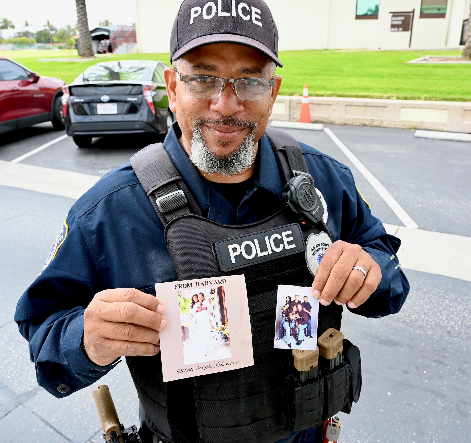 Officer Humphrey proudly holds up photos of his family that he keeps in his vehicle.