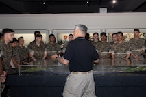 Len Howard, a docent with Marine Corps Recruit Depot San Diego Museum, gives a museum tour to U.S. Marines with Golf Company, 2nd Battalion, 1st Marine Regiment, during a visit at MCRD San Diego, California, April 29, 2024. The purpose of this visit is to familiarize the company on Special Duty Assignment opportunities as they weigh reenlistment options and career progression. (U.S. Marine Corps photo by Lance Cpl. Janell B. Alvarez)