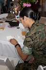 U.S. Marine Corps Staff Sgt. Debora Rodriguez with Headquarters and Service Battalion, discovers a note under her seat during a volunteer appreciation event at Marine Corps Recruit Depot San Diego, California, April 30, 2024. The event was held to show appreciation for the Marines, Sailors, and civilians that assisted with volunteer events across the Depot and the local communities. (U.S. Marine Corps photo by Lance Cpl. Janell B. Alvarez)