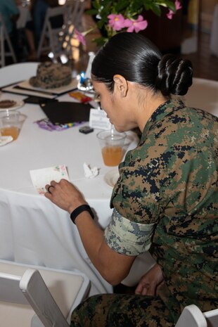 U.S. Marine Corps Staff Sgt. Debora Rodriguez with Headquarters and Service Battalion, discovers a note under her seat during a volunteer appreciation event at Marine Corps Recruit Depot San Diego, California, April 30, 2024. The event was held to show appreciation for the Marines, Sailors, and civilians that assisted with volunteer events across the Depot and the local communities. (U.S. Marine Corps photo by Lance Cpl. Janell B. Alvarez)