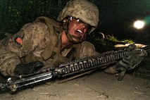 A U.S. Marines Corps recruit with Charlie Company, 1st Recruit Training Battalion, low crawls during The Crucible at Marine Corps Base Camp Pendleton, California, April 30, 2024. The purpose of the Alpha Draws is to train recruits in a simulated combat zone that induces stress, physical fatigue, and requires recruits to work together to complete the mission. (U.S. Marine Corps photo by Lance Cpl. Alexandra M. Earl)