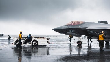 ATLANTIC OCEAN (May 11, 2024) Sailors move an F-35C Lightning II, attached to Strike Fighter Squadron (VFA) 147, in the rain on the flight deck of Nimitz-class aircraft carrier USS George Washington (CVN 73) in the Atlantic Ocean, May 11, 2024.