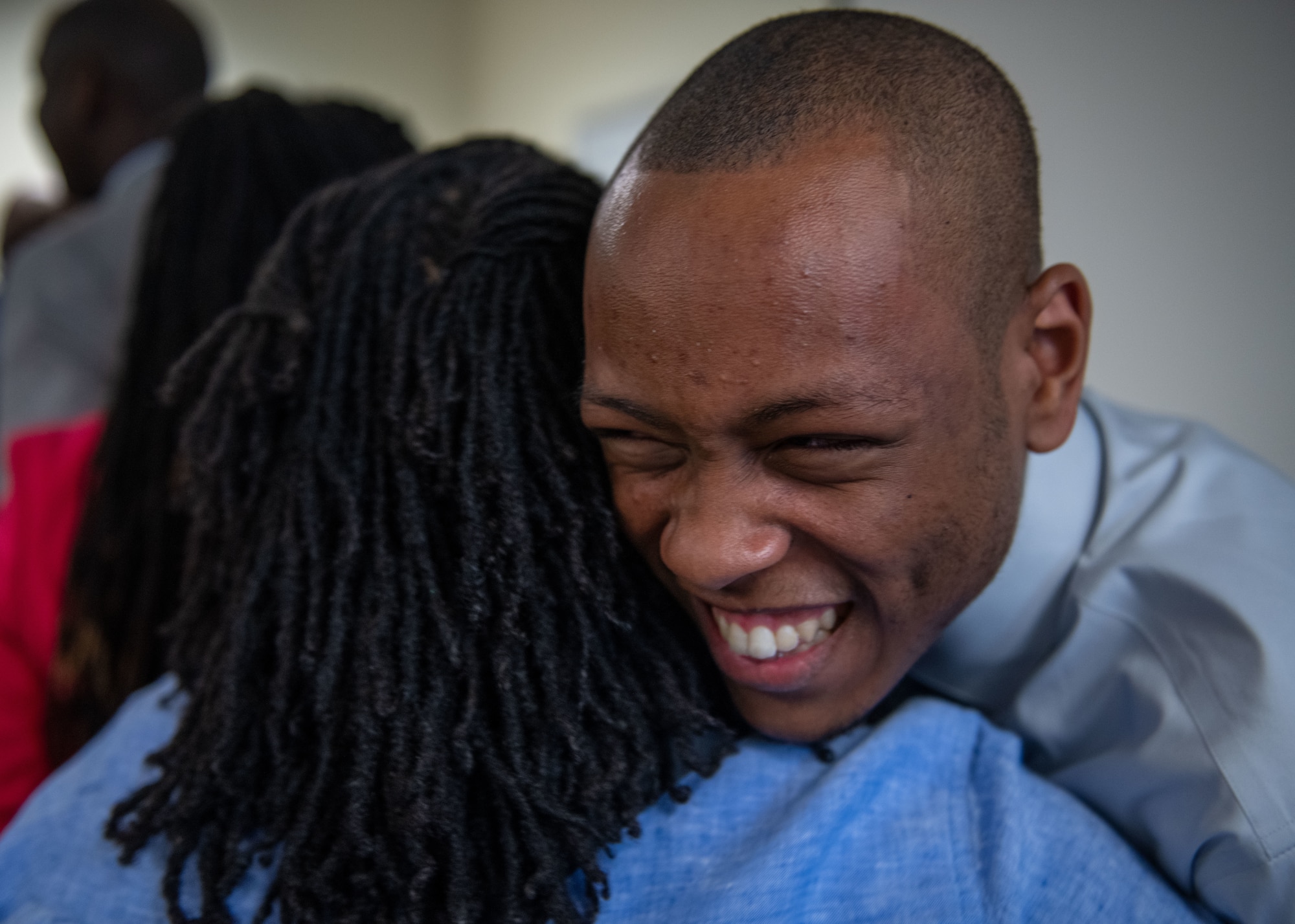 A graduate hugs a supporter.