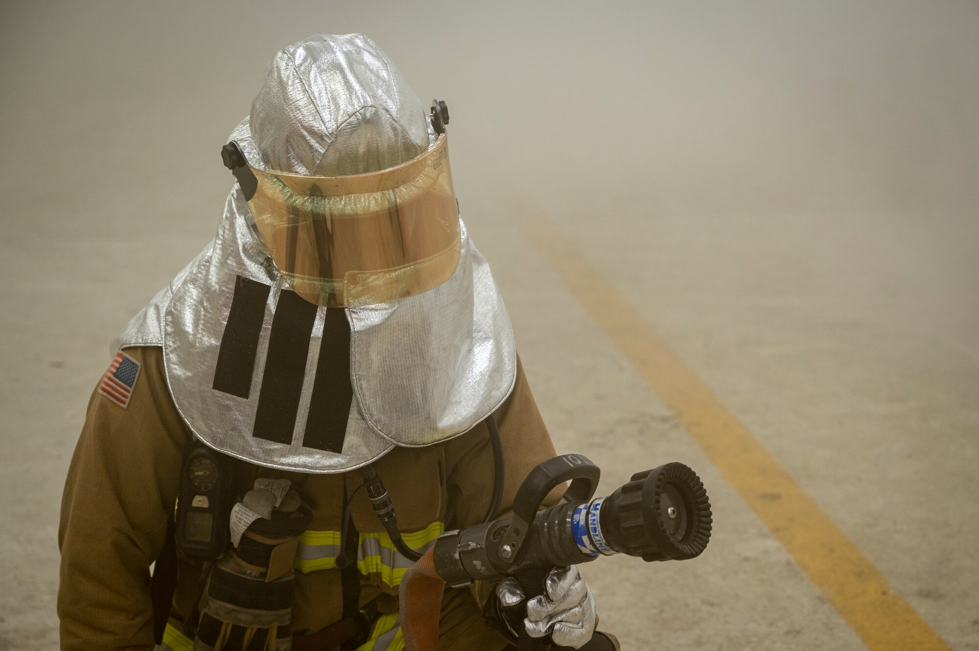 A U.S. Air Force firefighter assigned to the 51st Civil Engineer Squadron assesses hazards in a simulated fire during Beverly Herd 24-1 at Osan Air Base, Republic of Korea, May 13, 2024. The 51st CES rapid intervention team focused on locating the fire and victims while simultaneously relaying information to incident command. Routine training events like BH 24-1 are pivotal platforms for 51st Fighter Wing Airmen to refine their warfighting proficiencies through practical application, concurrently enhancing their ability to respond skillfully to contingencies. (U.S. Air Force photo by Senior Airman Sabrina Fuller-Judd)