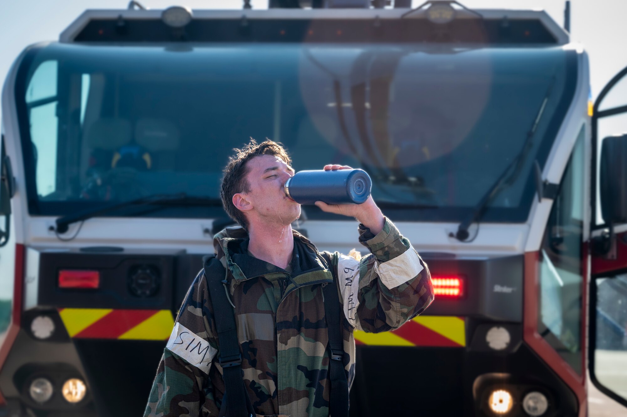 U.S. Air Force Senior Airman Steven Brost, 51st Civil Engineer Squadron firefighter and driver operator, hydrates after a simulated fire training during Beverly Herd 24-1 at Osan Air Base, Republic of Korea, May 13, 2024. 51st CES firefighters protect the 51st Fighter Wing mission by ensuring the safety of personnel, equipment and facilities. Routine training events like BH 24-1, are pivotal platforms for 51st Fighter Wing Airmen to refine their warfighting proficiencies through practical application, concurrently enhancing their ability to respond skillfully to contingencies. (U.S. Air Force photo by Senior Airman Sabrina Fuller-Judd)