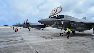 Four F-35B Lightning II jets are parked in a row on the flightline.