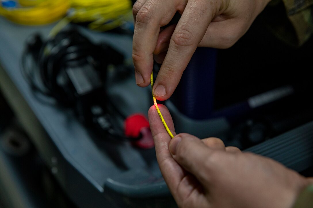 U.S. Air Force Tech. Sgt. Joseph Fredrick Jr, a cyber defense operations airman with 374th Communications Squadron Operating Location Bravo, 374th Communications Squadron, 374th Mission Support Group, and a native of California, performs a physical layer test using a visual fault locator at Marine Corps Air Station Iwakuni, Japan, April 19, 2024. (U.S. Marine Corps photo by Lance Cpl. David Getz)