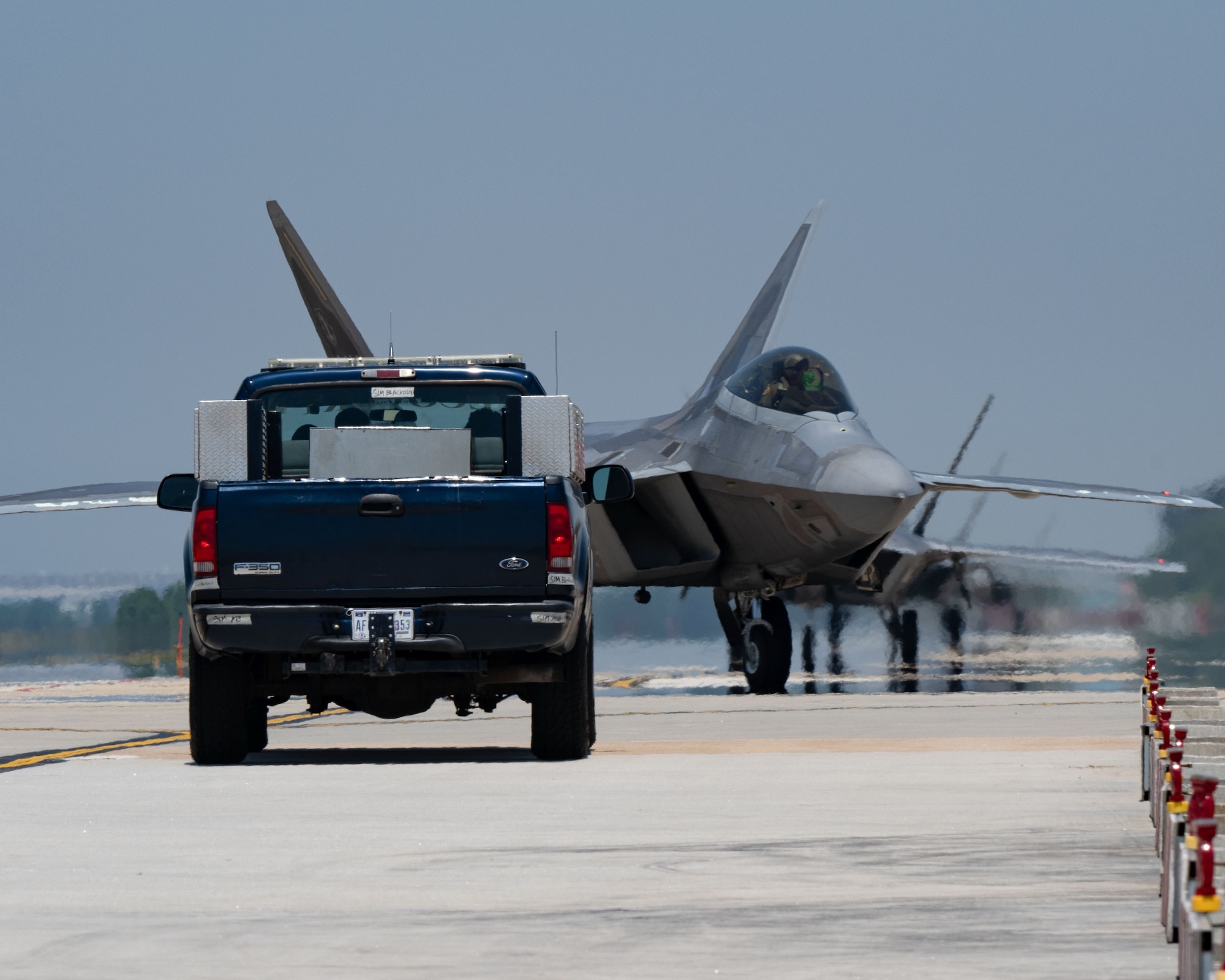 F-22 Raptors, assigned to the 19th and 199th Expeditionary Fighter Squadrons, taxi down the flightline at Kunsan Air Base.