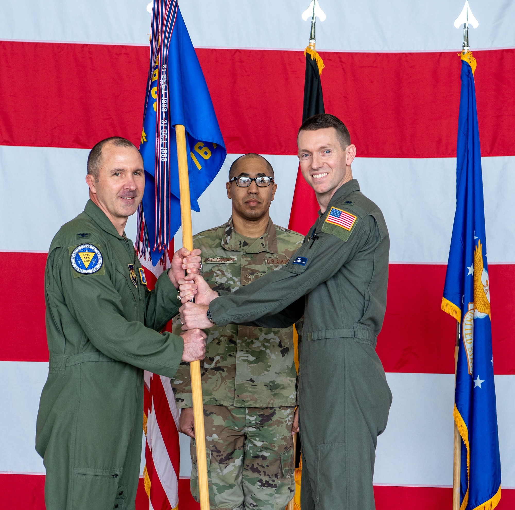 men hold guidon