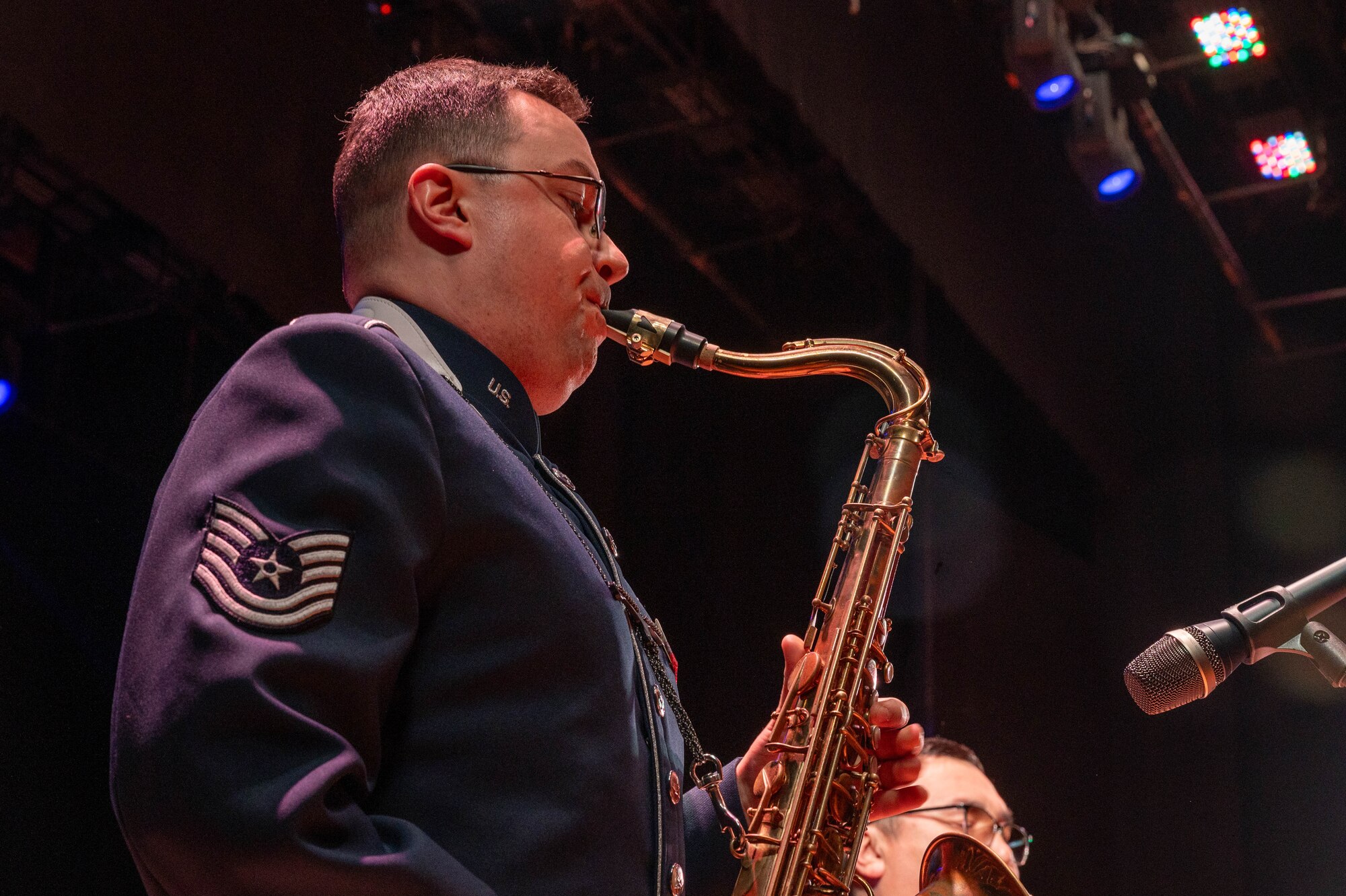 Man plays saxophone.