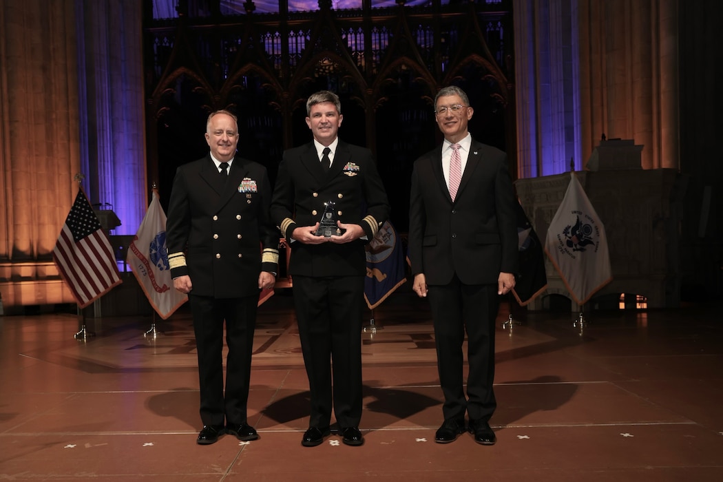 240509-N-N1526-1001 WASHINGTON, D.C. (May 9, 2024) Cmdr. Timothy J. Donahue, a Philadelphia native, poses for a photo with U.S. Navy Surgeon General Rear Adm. Darin Via and Joseph Caravalho, the president and CEO of the Henry M. Jackson Foundation for the Advancement of Military Medicine, after being awarded as the 2024 Navy Hero of Military Medicine at the Washington National Cathedral. Donahue was recognized for his work as the trauma medical director at Naval Medical Center Portsmouth, where he helped to spearhead the initiative to upgrade the military treatment facility to a Level II Trauma Center, the highest designation in the Navy. (U.S. Navy photo courtesy of Shmulik Almany)