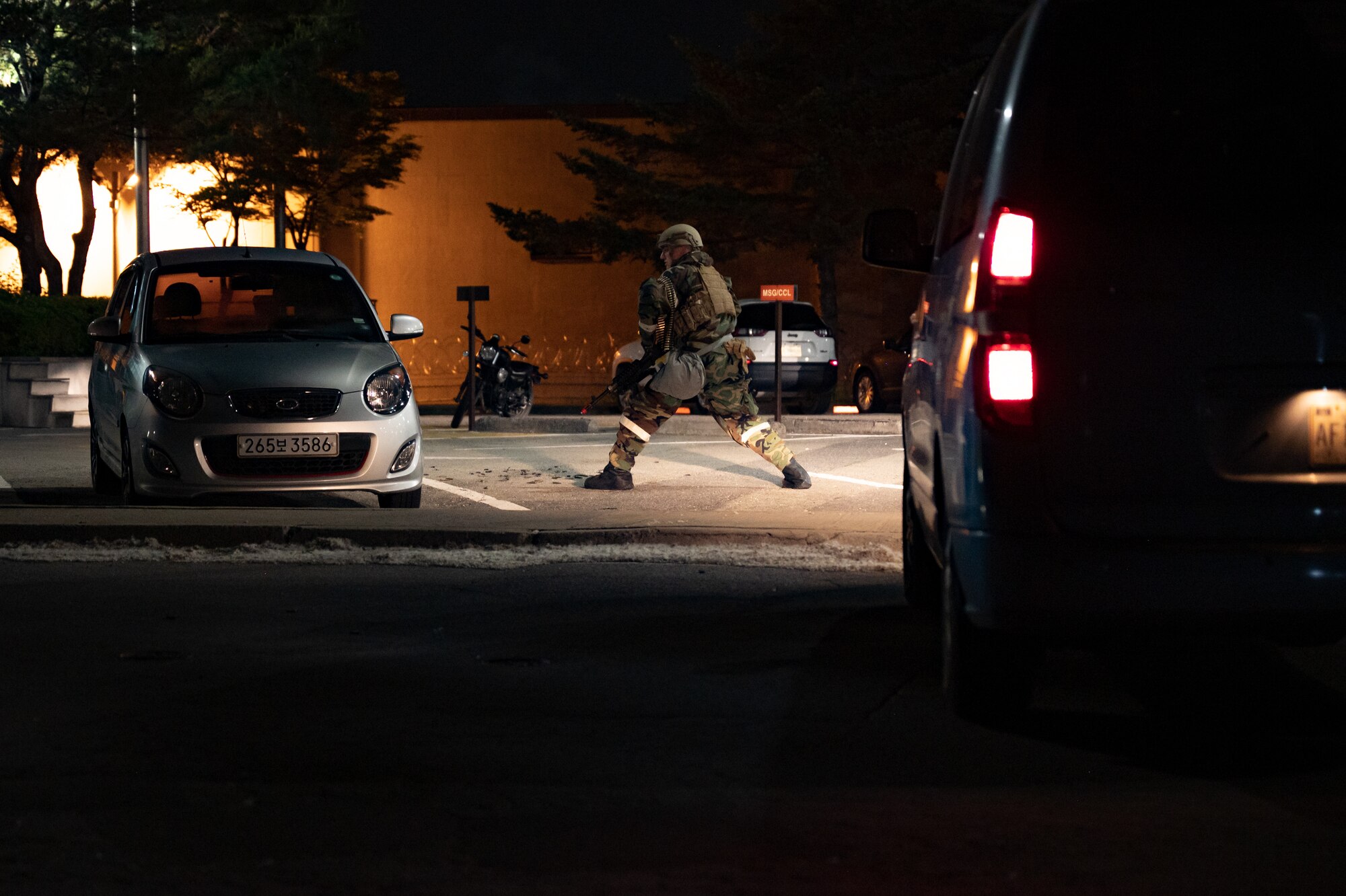 A U.S. Air Force Airman assigned to the 51st Security Forces Squadron responds to a simulated ground attack during Beverly Herd 24-1 at Osan Air Base, Republic of Korea, May 14, 2024. The Airmen of the 51st Fighter Wing continuously train to maintain the high level of full-spectrum readiness required to execute the mission proficiently and effectively. Routine training events like Beverly Herd are pivotal platforms for 51st Fighter Wing Airmen to refine their warfighting  proficiencies through practical application, concurrently enhancing their ability to respond skillfully to contingencies. (U.S. Air Force photo by Senior Airman Brittany Russell)