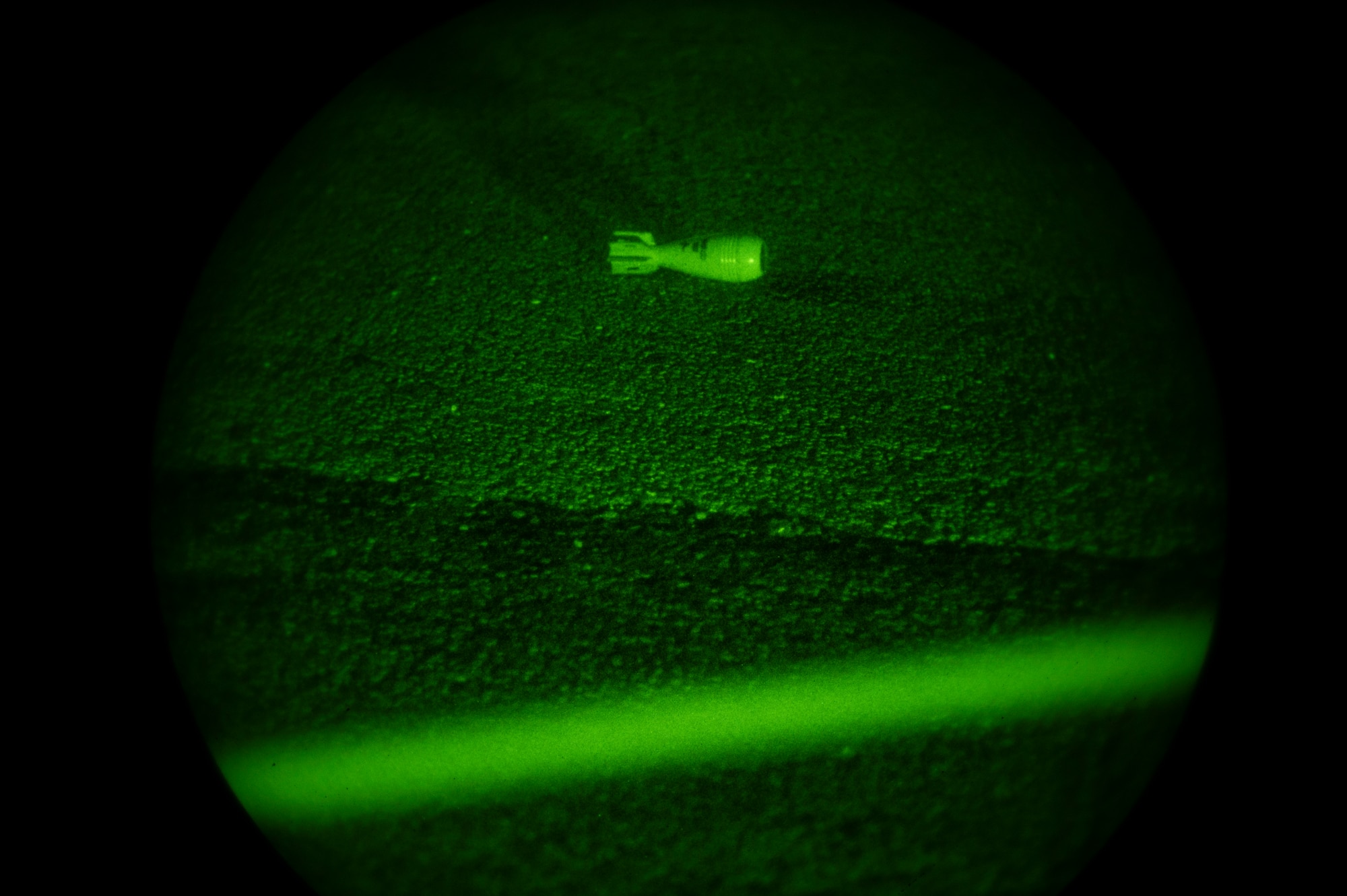 A simulated unexploded ordnance is positioned on the ground while Airmen assigned to the 51st Fighter Wing cordon off the area during Beverly Herd 24-1 at Osan Air Base, Republic of Korea, May 13, 2024. The Airmen of the 51st Fighter Wing continuously train to maintain the high level of full-spectrum readiness required to execute the mission proficiently and effectively. Routine training events like Beverly Herd are pivotal platforms for 51st Fighter Wing Airmen to refine their warfighting  proficiencies through practical application, concurrently enhancing their ability to respond skillfully to contingencies. (U.S. Air Force photo by Senior Airman Kaitlin Frazier)