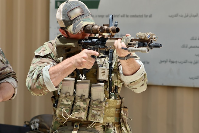 A Green Beret with 5th Special Forces Group (Airborne) sights in his M-4 carbine rifle during Eager Lion 24 at King Abdullah II Operations Training Center near Amman, Jordan, May 11, 2024. Eager Lion 24 is a multilateral exercise, with 33 participating nations, hosted by the Hashemite Kingdom of Jordan, designed to exchange military expertise, and improve interoperability among partner nations, and considered the capstone of a broader U.S. military relationship with the Jordanian Armed Forces. Jordan is one of U.S. Central Command’s strongest and most reliable partners in the Levant sub-region. (Photo has been altered for security purposes.