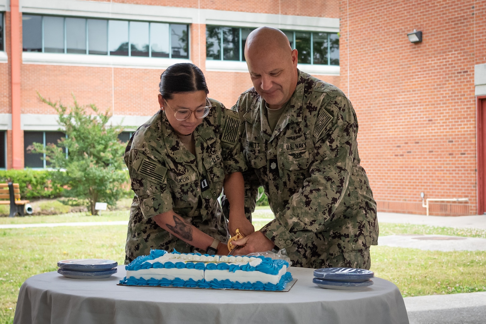 Navy Lieutenant Lauren Dixon, left, and Commander Carlton Bennett, right, cut a cake during a ceremony celebrating the 116th birthday of the U.S. Navy Nurse Corps during a ceremony held Monday, May 13, 2024 aboard Naval Health Clinic Cherry Point.