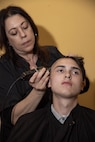 U.S. Marine Corps Recruit Elijah Mota with Hotel Company, 2nd Recruit Training Battalion, receives a haircut during a receiving event at Marine Corps Recruit Depot San Diego, May 6, 2024. During the receiving process recruits are checked for contraband, given haircuts, allowed a phone call home, and are issued their gear required for training. (U.S. Marine Corps photo by Lance Cpl. Janell B. Alvarez)