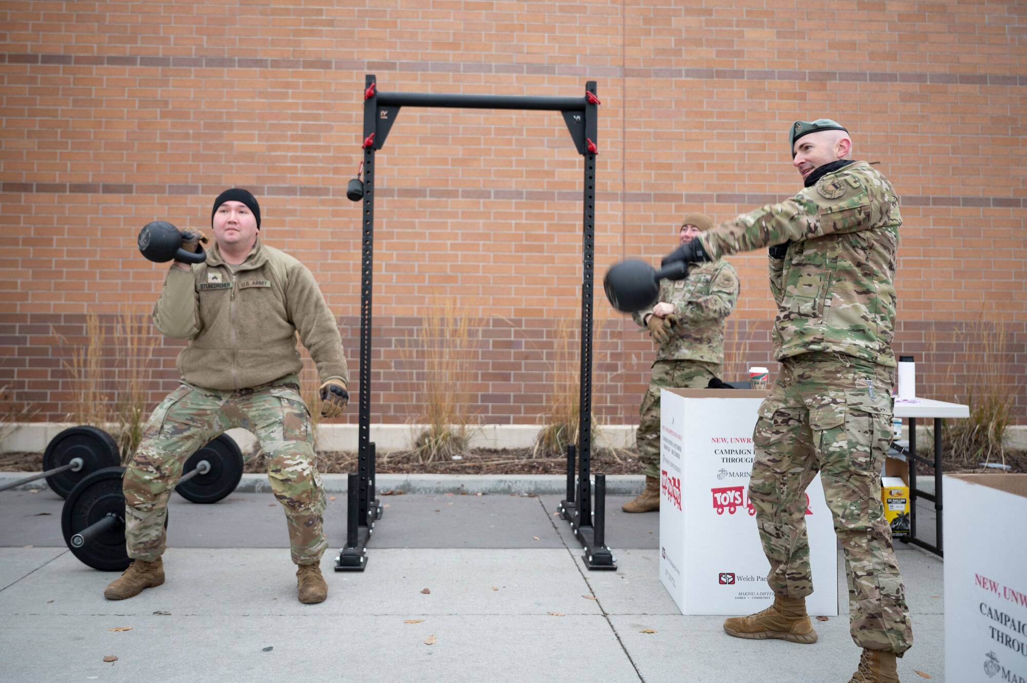 Airmen exercise with kettlebells.